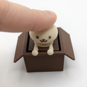 Cat Clicker with a finger photographed from the front