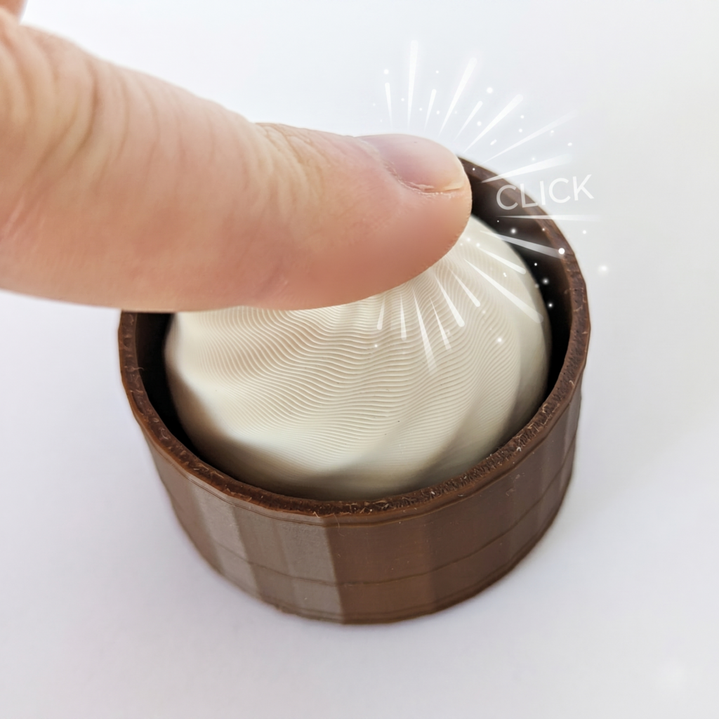 Dumpling Clicker with a finger photographed from the front top